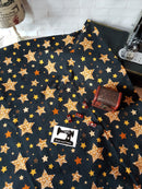 Gold Stars on Black - cotton lycra - 150cm wide