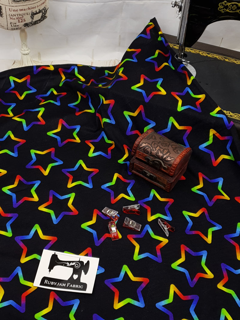 Rainbow Stars on Black - cotton lycra - 150cm wide - clearance