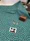 Black Polka Dots on Soft Green - cotton lycra - 150cm wide - clearance