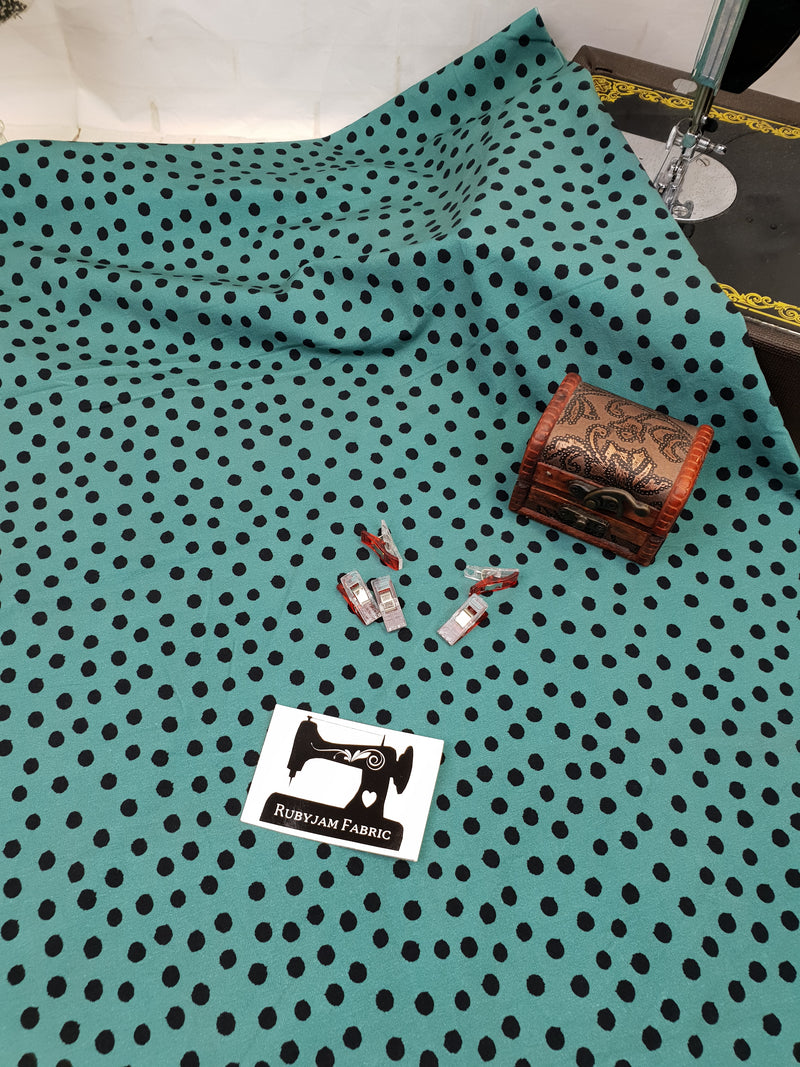 Black Polka Dots on Soft Green - cotton lycra - 150cm wide - clearance