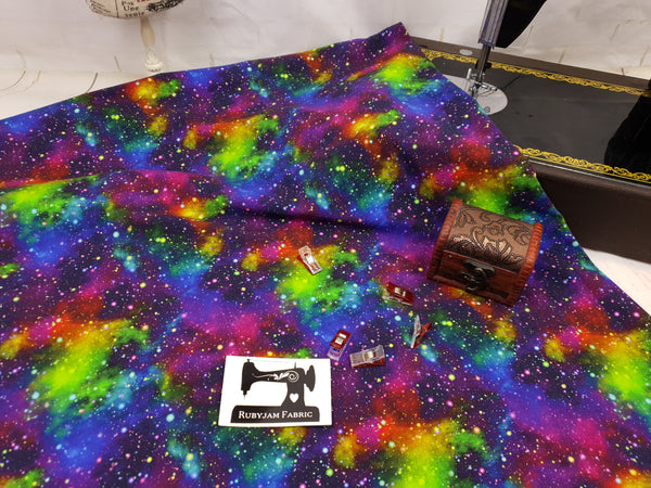 Our Intergalactic stretch knit fabric features a gorgeous rainbow galaxy design.
